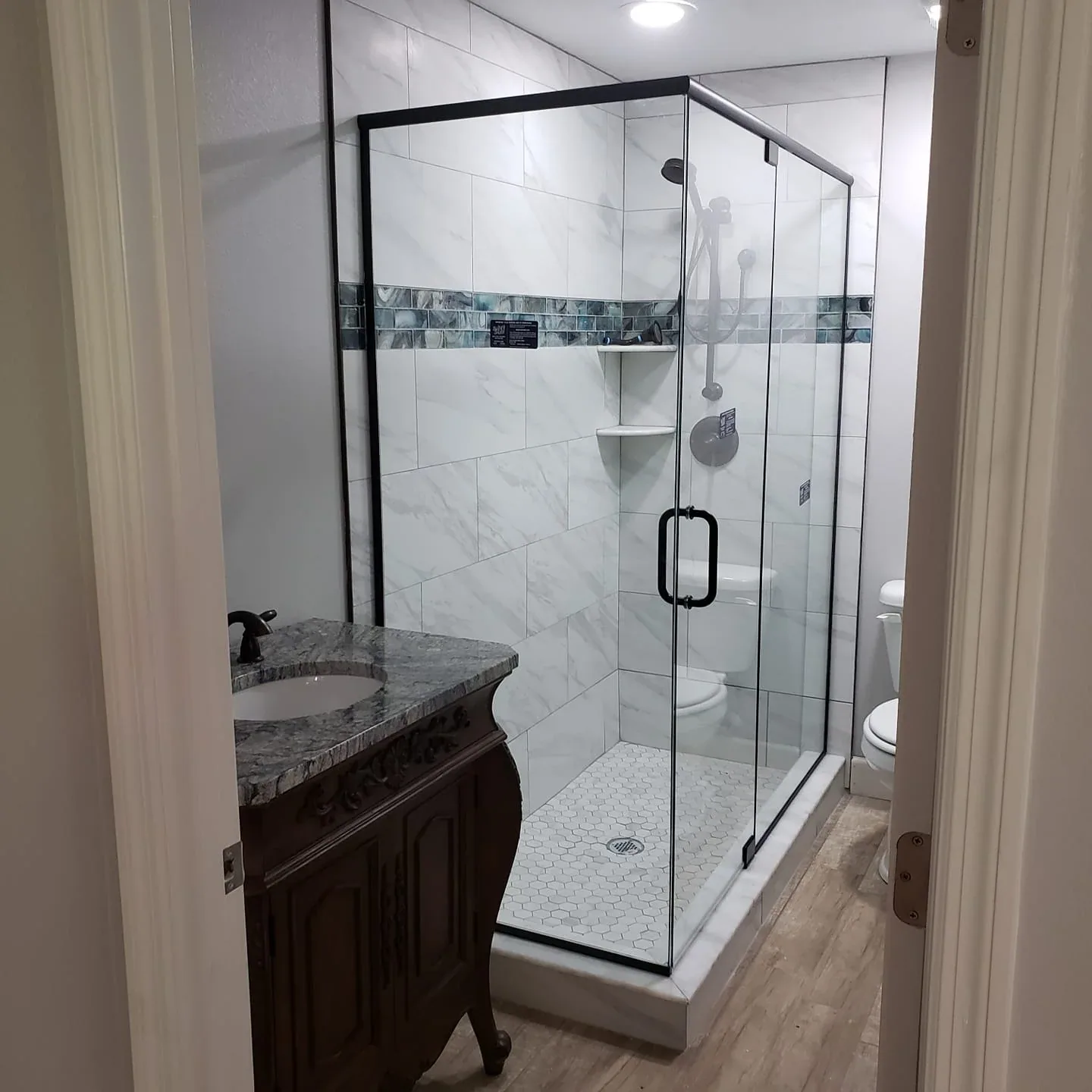 Black framed corner shower blue mosaic band in Rockledge