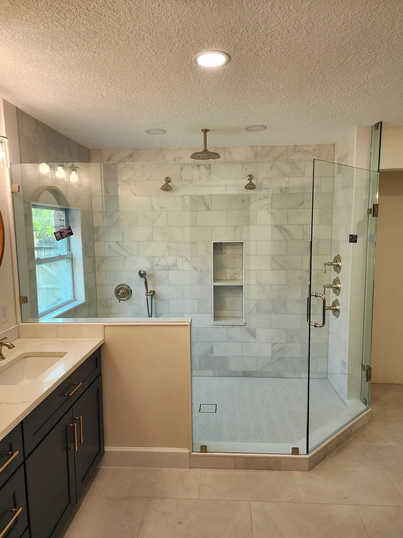 Ceiling rain head marble shower niche in Rockledge
