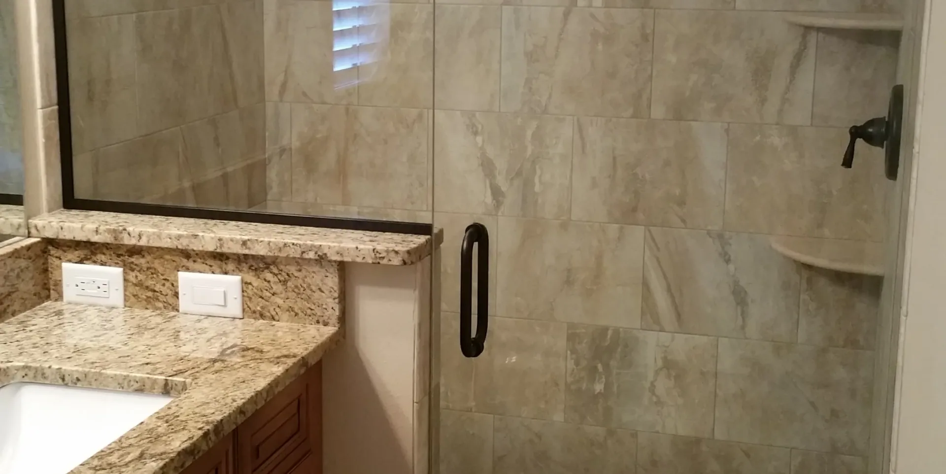 Granite vanity bronze shower door in Cocoa