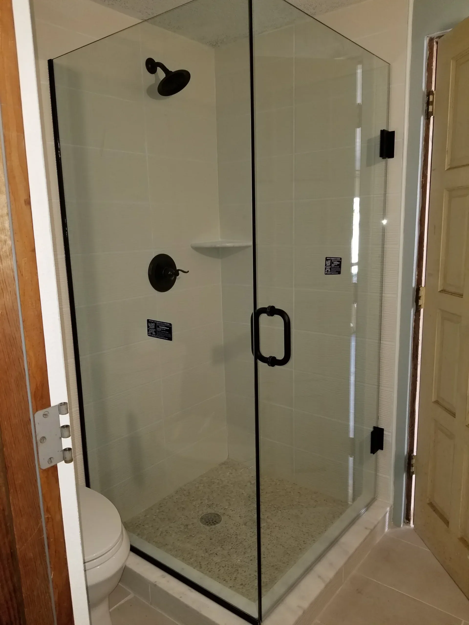 Oil rubbed bronze corner frameless shower in Satellite Beach