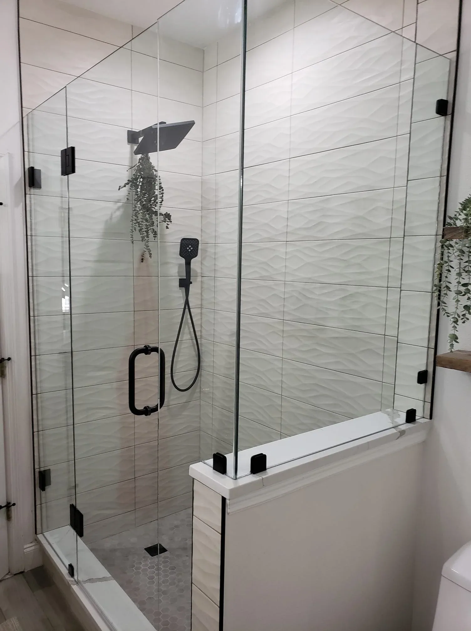 Wavy white tile frameless shower eucalyptus in Rockledge